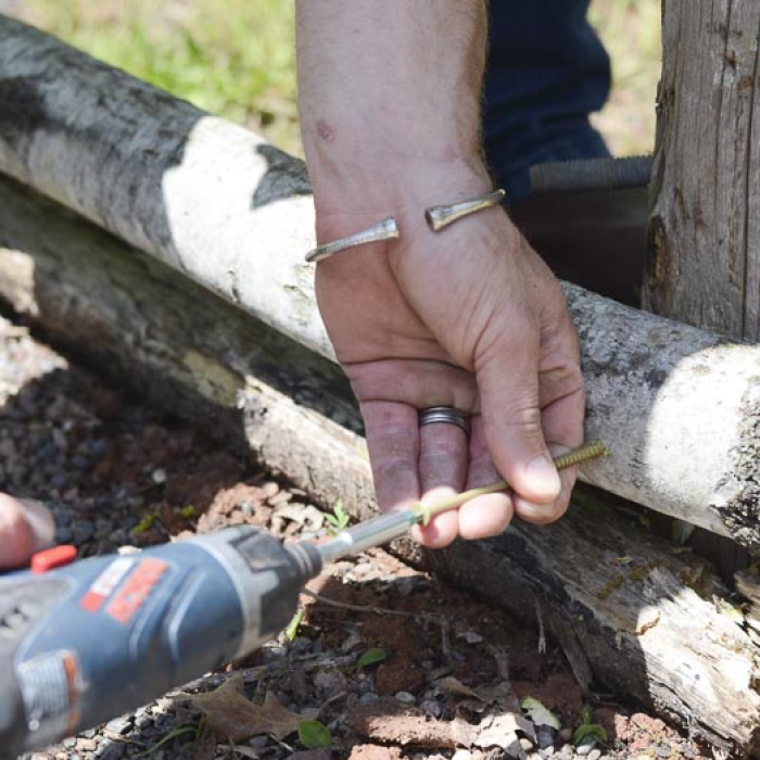 Screwing the railing into a fence for the garden fence